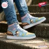 Side view of Snoopy custom name retro comic high top sneakers worn with blue jeans on outdoor steps.