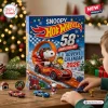 Snoopy x Hot Wheels 58th Anniversary Advent Calendar 2026 box with Snoopy and Woodstock in a red toy car on a wood table.