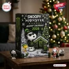 Snoopy x Monster Energy Christmas Advent Calendar with Snoopy in a beanie, Woodstock, and branded cans on a wooden table.