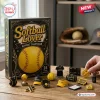 Softball Lover Advent Calendar 2026 box with 24 acrylic ornaments including tiny gloves, balls, and jerseys on a table.