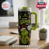 Stanley The Grinch Resting Face 40oz Tumbler with a green handle, black exterior, and festive holiday Grinch graphics.