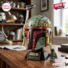 Front three-quarter view of the green and red Star Wars 50th Anniversary Boba Fett Helmet Brick Set on a wooden desk.