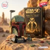 Front view of the Boba Fett Helmet Brick Set with its packaging box and minifigure outdoors.