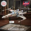 Star Wars 50th Anniversary X-Wing Starfighter tree ornament on a gold hanger with white and red hull details.