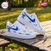 Side view of Stitch Down Right Perfect Blue Awareness Air Force 1 Sneakers on wooden table.