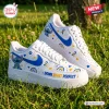 Side view of Stitch Down Right Perfect Blue Awareness Air Force 1 Sneakers on grass.
