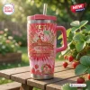 Front view of Strawberry Shortcake 53rd Anniversary Stanley Tumbler on wooden picnic table.