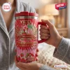 Close-up view of a pink anniversary tumbler with strawberry graphics.