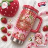 Front view of Strawberry Shortcake 53rd Anniversary Stanley Tumbler with pink tie-dye pattern and surrounding fresh strawberries.