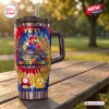 Front view of the Super Mario 41st Anniversary Stanley Tumbler on a wooden table outdoors.