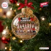 Front view of a Team USA Basketball 2026 World Champions glass ornament hanging on a pine tree with golden confetti.