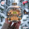 Hand holding a Tennessee Volunteers 135th Anniversary Christmas Ornament featuring a miniature stadium and dog.