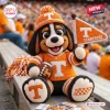Front view of a Tennessee Volunteers mascot crocheted plush doll holding a small pennant and a football on a bleacher.