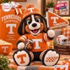 Front view of a crocheted Tennessee Volunteers mascot plush doll holding a small football and a pennant.