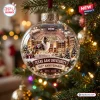 Close-up of a glass sphere ornament featuring a stadium, dog, and Texas A&M University 150th Anniversary text on a tree.