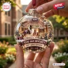 Close-up of a Texas A&M University 150th Anniversary Glass Christmas Ornament featuring a dog mascot and stadium scene inside.