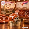 Close-up of a metallic orange football helmet token in front of a Texas Longhorns Monopoly board game box.