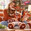 A smiling woman hugging a large Texas Longhorns mascot plush pillow on a couch.