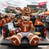 Texas Longhorns mascot plush pillow sitting in the back of a pickup truck at a tailgate.