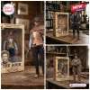The Good The Bad and The Ugly Blondie 60th Anniversary Hot Toys action figures with branded collector packaging on a desk.