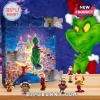 The Grinch 2026 Christmas Advent Calendar with 24 perforated doors, illustrated background, and miniature holiday figures.