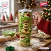 Hand holding a green 40oz tumbler with holiday baking graphics and personalized text in a kitchen setting.