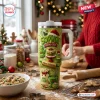 Lifestyle view of a green personalized 40oz tumbler with Christmas baking illustrations on a wooden kitchen counter.
