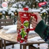 Hand holding a red 40oz Stanley tumbler with Grinch holiday graphics and a sign reading Naughty Nice I Tried.