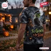 Back view of a person wearing a Grinch Halloween pumpkin shirt featuring a spooky forest scene and stylized text.