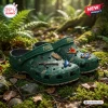 Close-up view of green Ocarina of Time clogs with themed charms resting on forest moss.