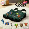 Front view of The Legend of Zelda Ocarina of Time clogs with charms on a fuzzy rug.