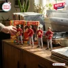 The Monkees 60th Anniversary Collectible Figure set featuring four band members in red jackets on a wooden desk.