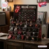 The Rolling Stones Advent Calendar 2026 featuring band memorabilia, guitar miniatures, and the iconic tongue logo on shelves.