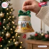 The Wizard of Oz 87th Anniversary Bell Ornament with yellow brick road scene, green bow, and ruby slipper charm.