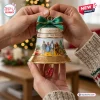 The Wizard of Oz 87th Anniversary Bell Ornament featuring character illustrations, green ribbon, and ruby slipper charms.