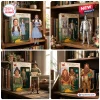 The Wizard of Oz 87th Anniversary Figure set featuring Dorothy, Tin Man, Scarecrow, and Lion in window display boxes.