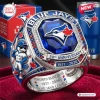 Closeup of a Toronto Blue Jays 50th Anniversary Championship Ring featuring a large blue gemstone and mascot detail.
