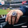 Closeup of a hand wearing a Toronto Blue Jays 50th Anniversary Championship Ring at a stadium.