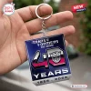 Hand holding a square Transformers 40th anniversary double sided keychain with 1986 to 2026 dates.