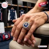USA Basketball FIBA 2026 World Champions Ring featuring a blue center stone and gold detailing worn on a hand.