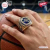 USA Basketball FIBA 2026 World Champions ring with a large blue center stone, gold band, and detailed athletic engravings.