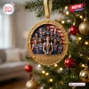 Round gold ornament featuring a USA basketball team portrait in front of a flag, hanging on a decorated pine tree.