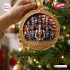 Hand holding a round USA FIBA Women’s World Cup 2026 Champions ornament against a Christmas tree background.