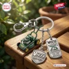 Closeup of a Victa Mowers 75th Anniversary metal keychain with miniature mower pendant.