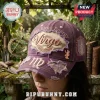 Virgo Big Virgo Energy Distressed Purple Baseball Cap with embroidered gold font and lace details on a vintage garden table.