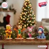 Winnie the Pooh 100th Anniversary Christmas Advent Calendar figurines of Pooh, Tigger, Piglet, and Eeyore on a wood shelf.