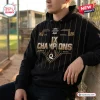 Front view of WPBL Los Angeles Queens 2026 Champions Black Hoodie with gold pinstripes worn outdoors.