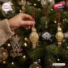 WWE The Holiday Main Event 2026 Advent Calendar ornaments including championship belts and ring hanging on a Christmas tree.