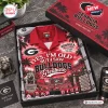 Top view of a red Hawaiian shirt featuring Georgia Bulldogs stadium imagery and football-themed text in a gift box.