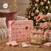 Close-up of pink ballet advent calendar with numbered doors and miniature charms displayed on a tiered stand.